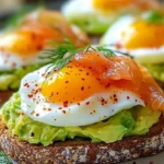 Avocado toast topped with a poached egg and smoked salmon on a plate