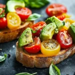 Avocado, Tomato, and Basil Bruschetta arranged on a wooden board