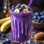 Delicious Banana-Blueberry Smoothie in a glass with fresh fruit
