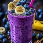 Healthy banana-blueberry smoothie in a glass with fresh fruits