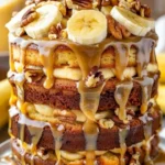 Slice of Banana Walnut Fudge Cream Cake with walnuts on top