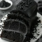 Delicious Black Velvet Cake Roll with cream filling on a white plate