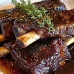 Delicious braised beef short ribs served with vegetables and sauce