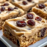 Delicious brown butter oatmeal raisin cookie bars on a rustic wooden plate.