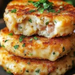 Cheesy tuna melt patties served on a plate with fresh ingredients.