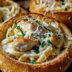 Delicious Chicken Alfredo served in crispy garlic bread bowls.