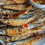 Delicious crispy fried fish served on a plate with garnish