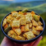 Bowl of Dill Pickle Chex Mix with crispy snacks and dill pickle flavor