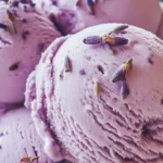 Delicious homemade honey lavender ice cream in a bowl with lavender sprigs.