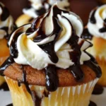 Delicious Boston Cream Pie cupcakes topped with chocolate and cream