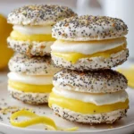Lemon and poppy seed meringue sandwiches arranged on a plate