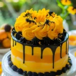 Lemon mango cheesecake with a swirl pattern and fresh fruit topping