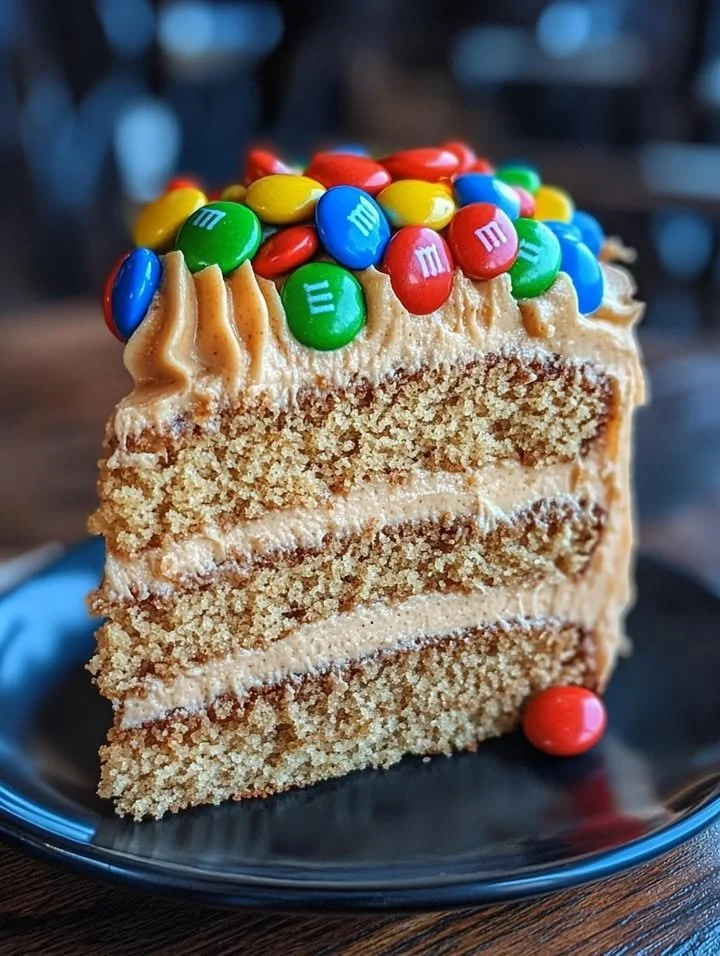 M&M's Peanut Butter Cake with Peanut Butter Frosting displayed on a cake stand