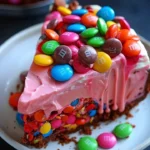 Delicious Pink Paradise No-Bake M&M and Toffee Cheesecake served on a plate