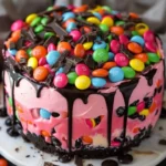 Pink Paradise No-Bake M&M Chocolate Cheesecake topped with colorful candies