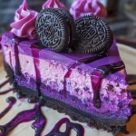 Purple Velvet Oreo Cheesecake topped with creamy frosting and Oreo crumbles