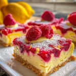 Delicious raspberry lemon cheesecake bars on a white plate