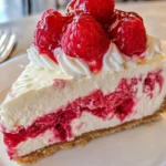 Delicious Raspberry White Chocolate Cheesecake with fresh raspberries and chocolate drizzle