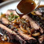 Slow cooker brisket served with balsamic onion gravy on a plate
