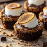 Delicious S'mores Brownie Cups topped with marshmallows and chocolate.