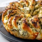Spinach-Artichoke Pull-Apart Star Bread served on a rustic table