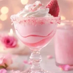 A refreshing Strawberry Rose Mocktini garnished with fresh strawberries and rose petals.