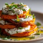 Sweet Potato and Burrata Stacks garnished with herbs on a wooden board