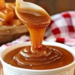 Jar of homemade caramel sauce drizzled over a dessert