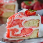 Velvet Lemon Cream Cake with a swirl of strawberry, garnished with fresh strawberries.