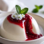 White Burrata Panna Cotta with a liquid raspberry core served elegantly.