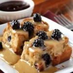 Delicious wild berry bread pudding drizzled with orange sauce