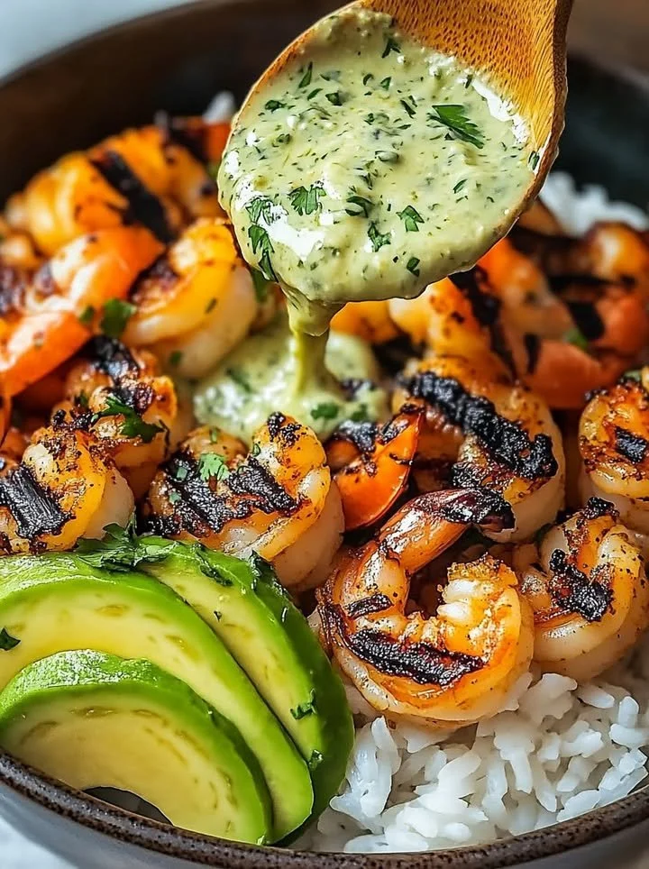 Zesty shrimp avocado rice bowls with cilantro lime sauce garnished with fresh cilantro